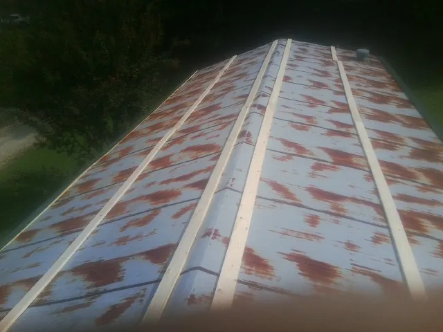 Rusted metal roof panels with new wood purlins before replacement — Storm Damage Roof Repair in Bath by Roofing Brothers